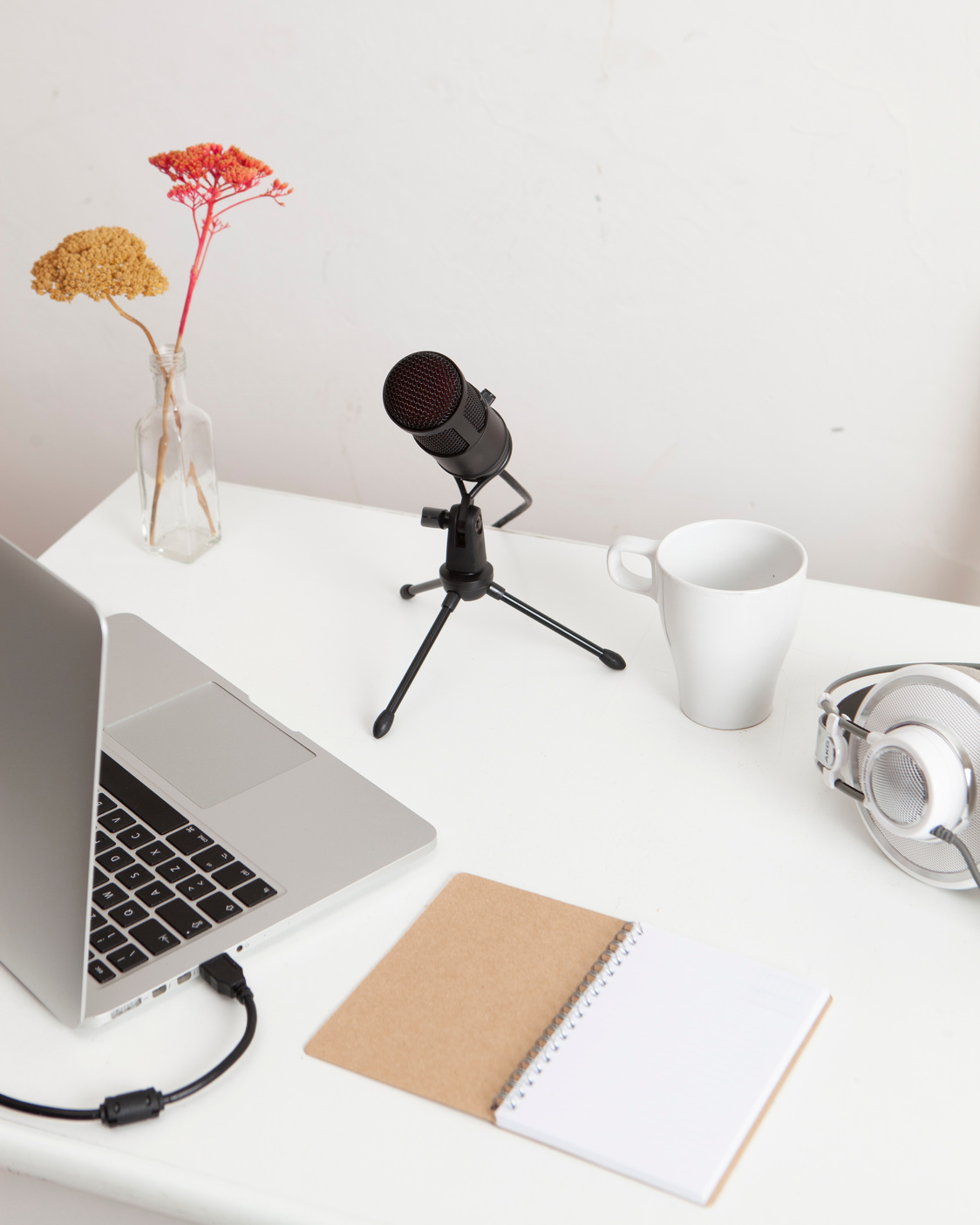 Headphones, Microphone, Laptop and Notebook on White Desk